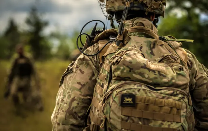 A British Army Soldier marches back toward his rally point during the field training portion of the Saber Strike exercise.